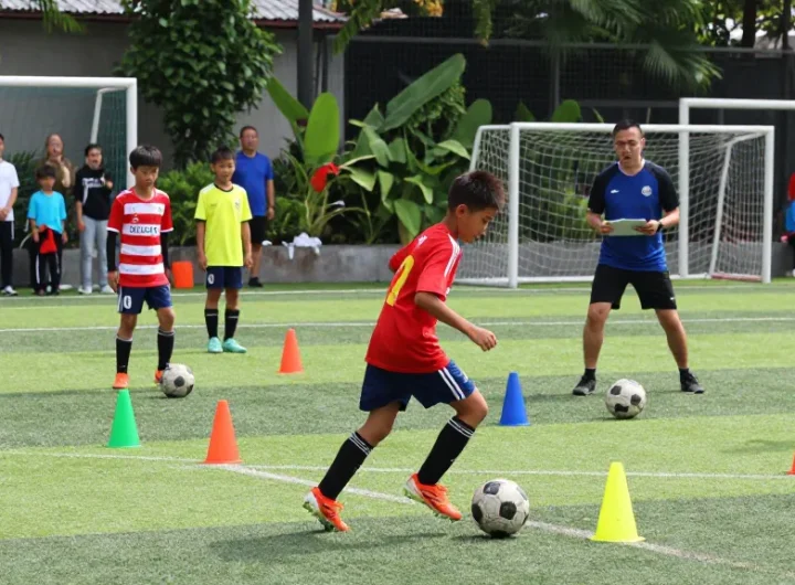 Youth soccer players practicing at mequonsoccerclub.com field, vibrant uniforms and energetic drills.